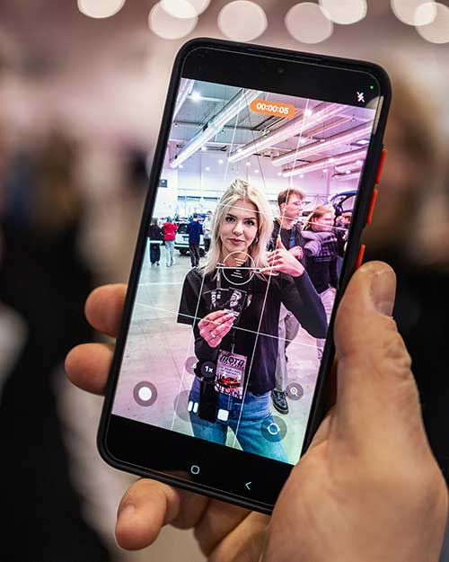 Nagrywanie w trakcie – Roksana z ekipy Razor’s Edge w kadrze telefonu, gotowa do akcji.